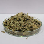 Neem Leaves in a glass container on a white background