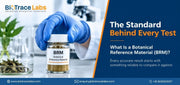 Gloved hand holding a jar labeled BRM Botanical Reference Material with dried botanicals and lab equipment in the background.